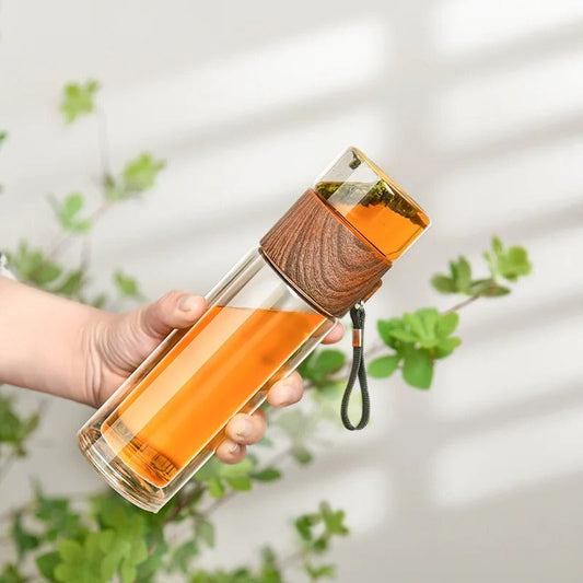 Glass thermos bottle with stainless steel tea infuser and wood accent